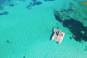 Vue aérienne d'un catamaran dans une eau turquoise